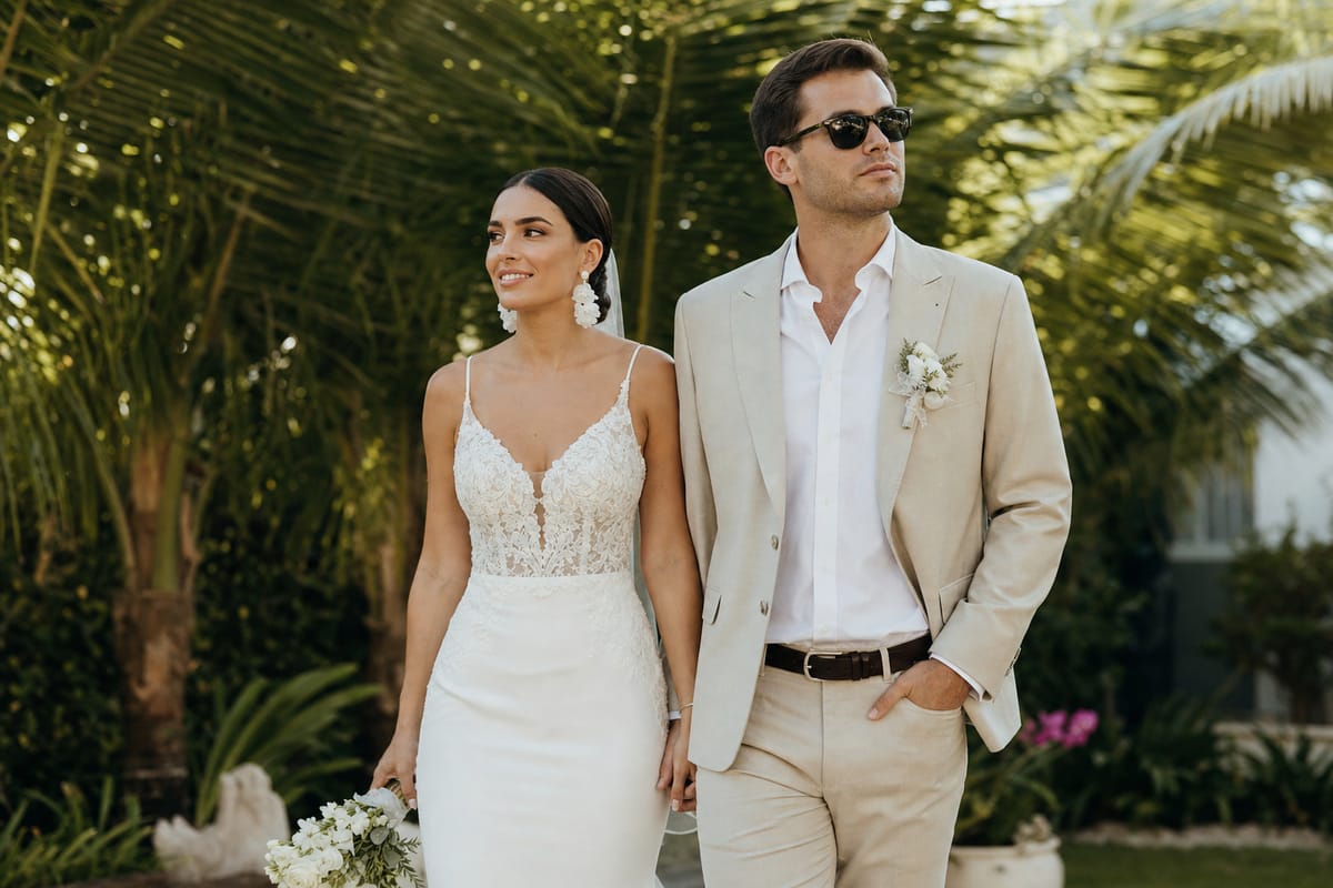 A radiant couple looking cool and composed in a tropical Bali garden